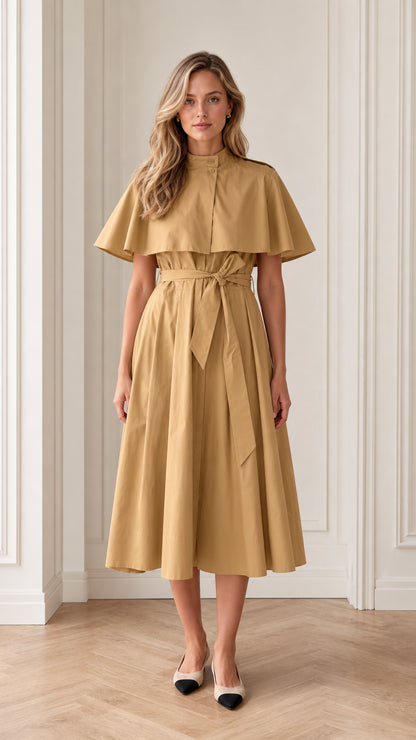 Front view of model wearing camel trench capelet belted midi dress