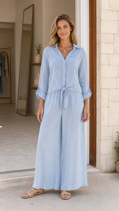 Front view of light blue button-down wide leg jumpsuit