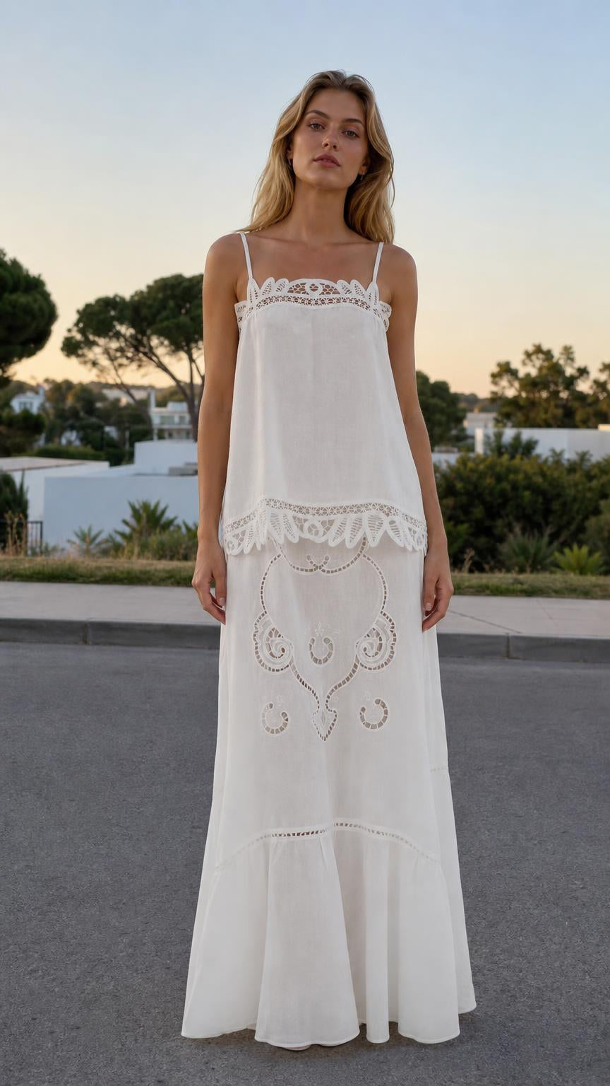 Front view of woman wearing white lace camisole and maxi skirt set