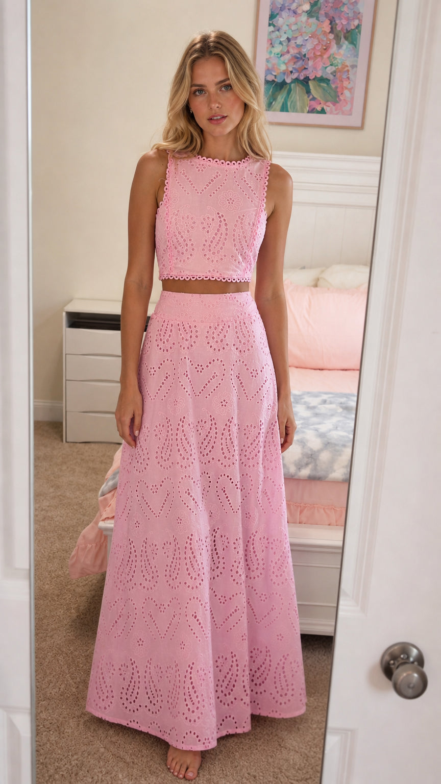 Front view of model wearing pink eyelet embroidered crop top and maxi skirt set