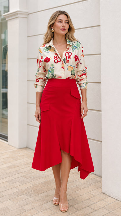 Model wearing cream floral button down shirt and red asymmetric midi skirt front view