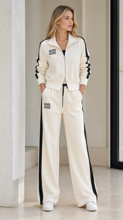 Front view of model wearing Cream zip-up track jacket and wide-leg pants two-piece set