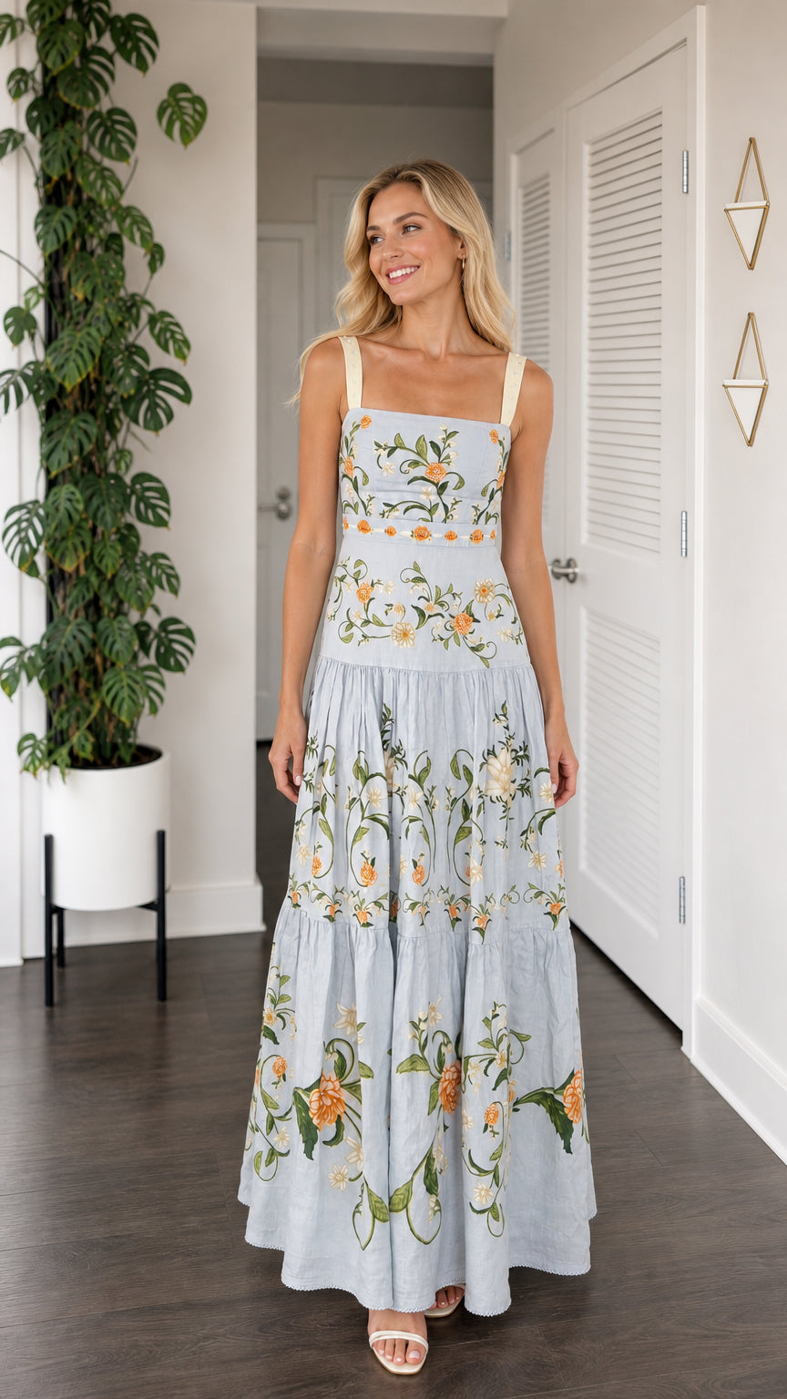 Front view of model wearing light blue floral embroidered tiered maxi dress