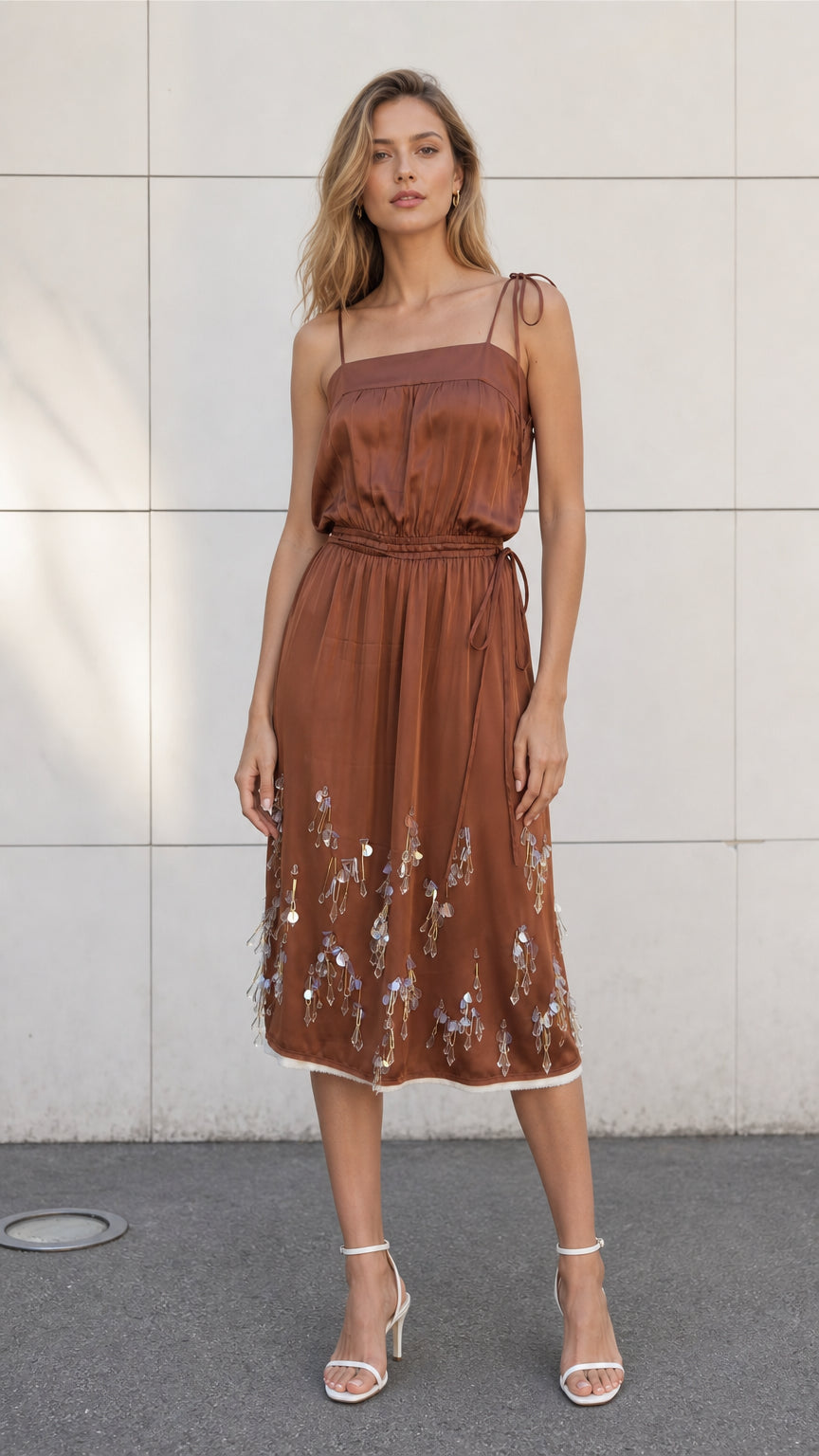Front view of model wearing brown satin embellished midi slip dress