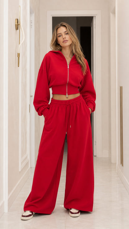 Front full-length view of woman wearing red cropped zip-up hoodie and matching wide-leg sweatpants