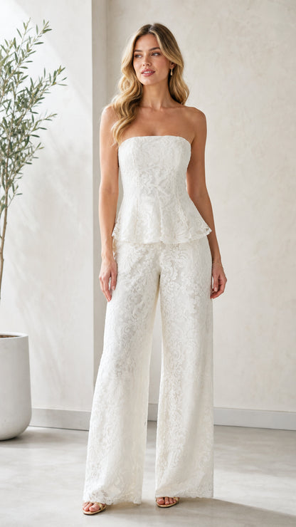 Model wearing white strapless lace peplum wide leg jumpsuit front view