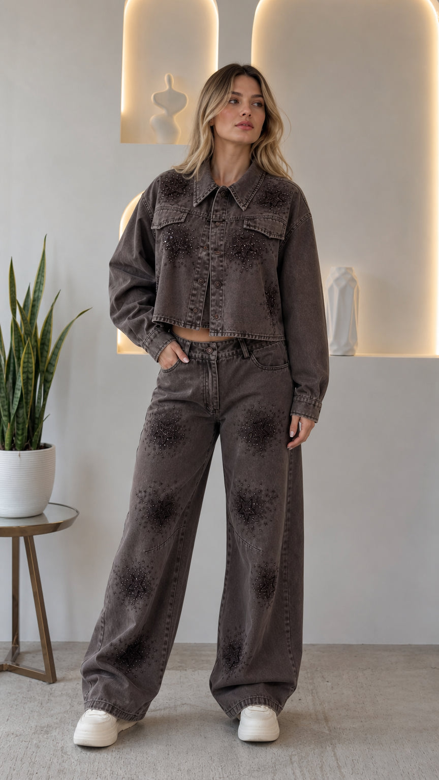 Front view of woman wearing washed grey rhinestone star cropped denim jacket and wide leg pants set