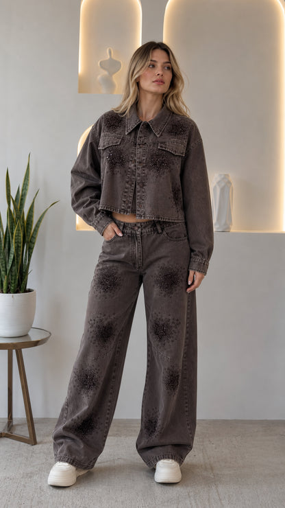 Front view of woman wearing washed grey rhinestone star cropped denim jacket and wide leg pants set