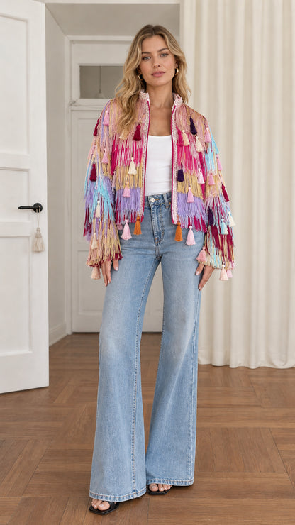 Full front view of model wearing pink multicolor tiered fringe tassel jacket with wide-leg jeans
