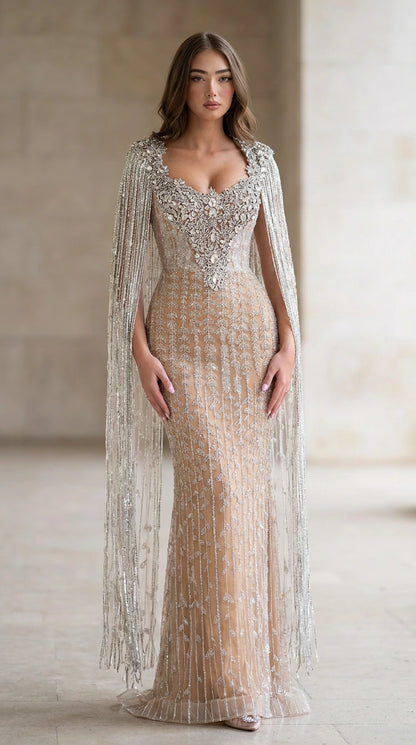 Front view of nude crystal embellished cape sleeve evening gown