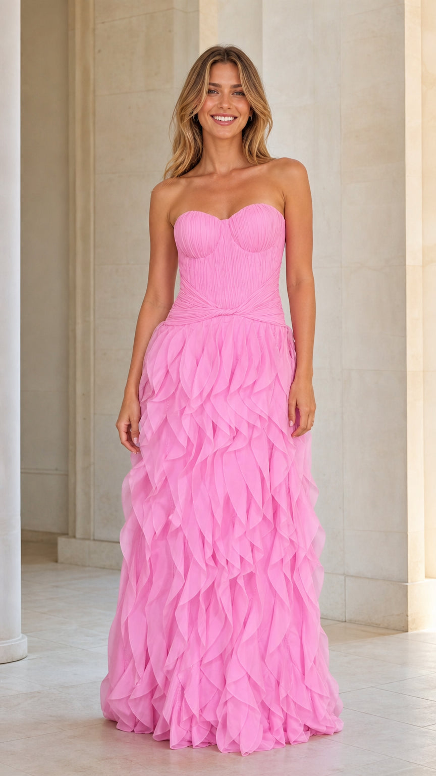 Front view of model wearing pink strapless ruffle maxi dress