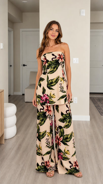 Front view of model wearing beige tropical floral strapless top and wide leg pants set