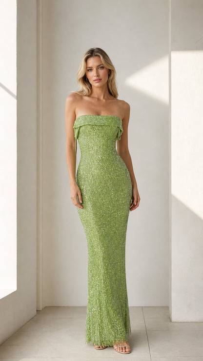 Model wearing green glittering strapless maxi dress front view