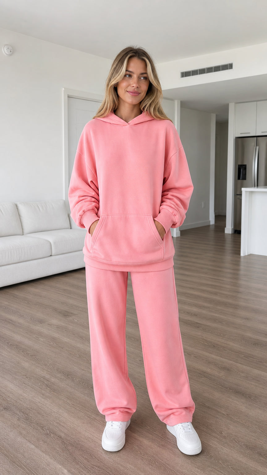 Front view of model wearing pink oversized hoodie and sweatpants set