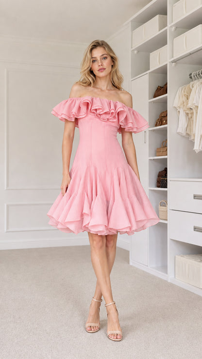 Front view of model wearing pink off-shoulder ruffle cocktail dress
