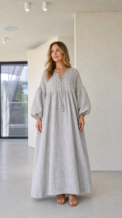 Front view of model wearing grey lace-up boho maxi dress with long balloon sleeves