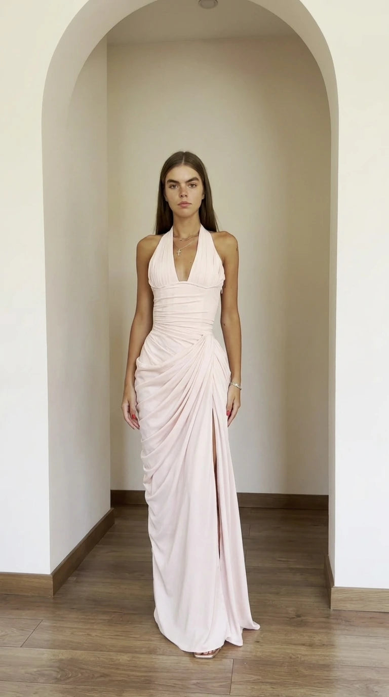 Front view of model wearing blush pink halter ruched maxi dress