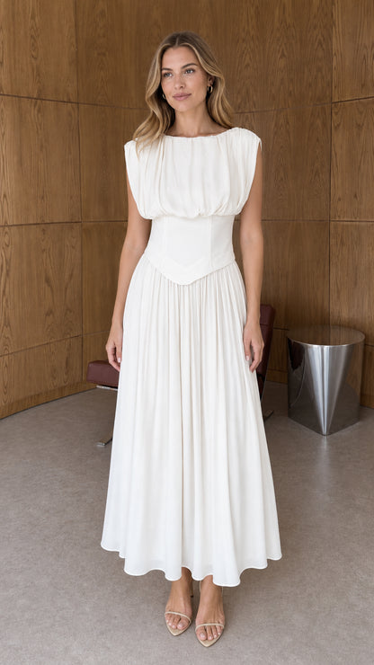 Front full-length view of woman wearing white sleeveless pleated basque waist midi dress