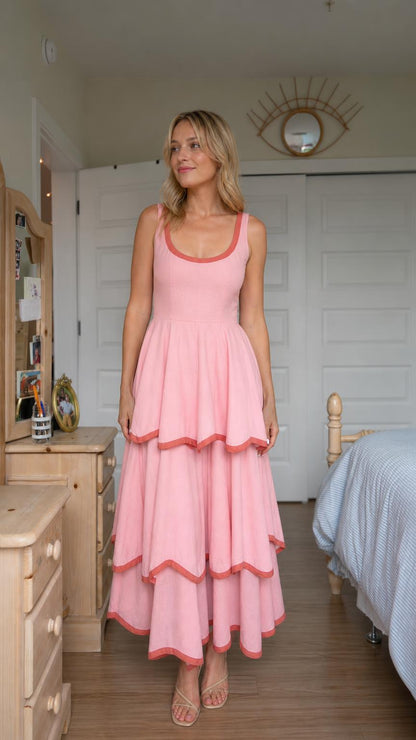 Front view of woman wearing pink tiered maxi dress with contrast trim