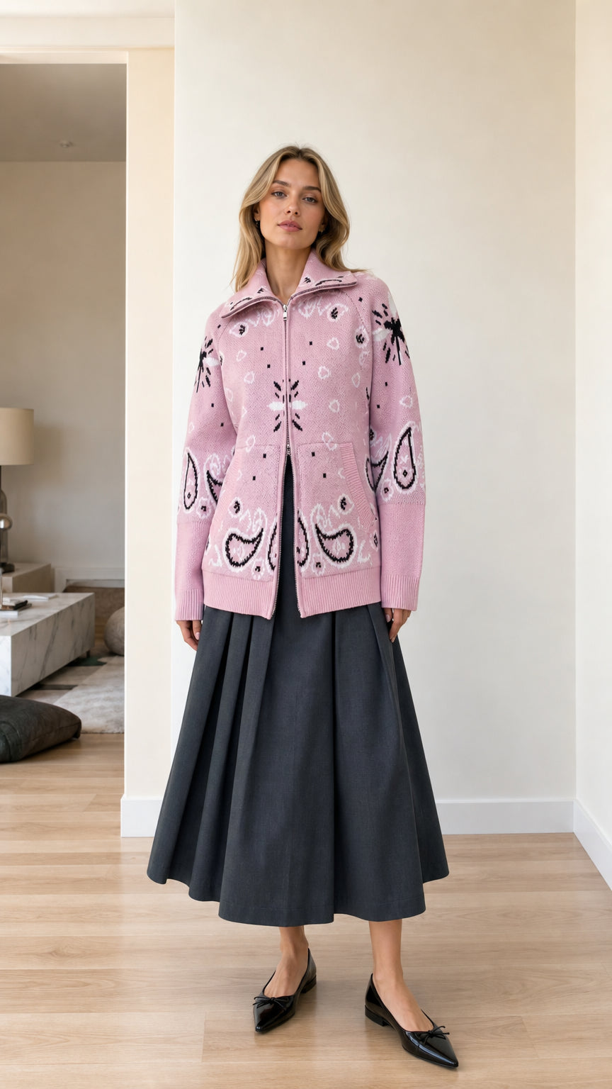 Front full view of woman wearing pink paisley jacquard zip-up knit cardigan with charcoal skirt