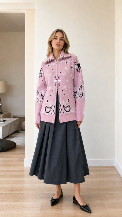 Front full view of woman wearing pink paisley jacquard zip-up knit cardigan with charcoal skirt