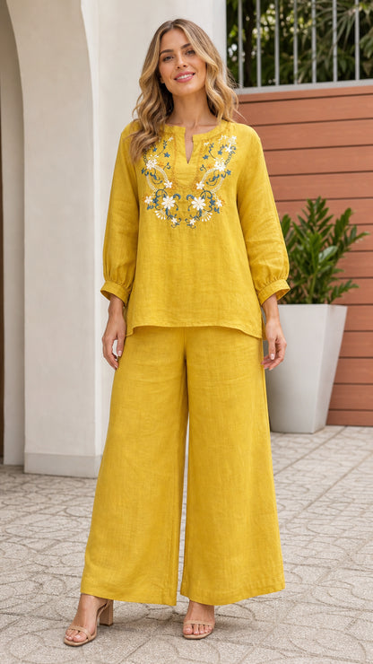 Front view of woman wearing yellow embroidered top and wide leg pants set