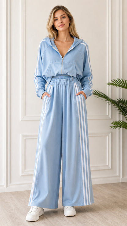 Front full-length view of woman wearing Light Blue 2-piece striped cropped hoodie and wide leg sweatpants set