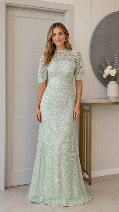 Front full-length view of woman wearing sage green beaded illusion evening gown with half sleeves