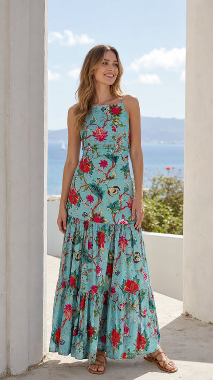 Front view of woman wearing turquoise floral tiered maxi dress