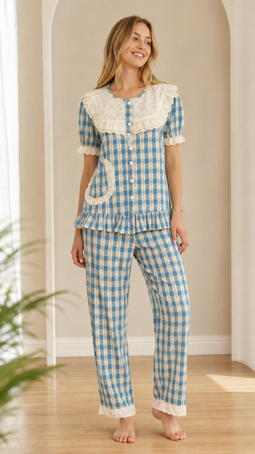 Front view of model wearing blue gingham short sleeve pajama set with embroidered lace collar