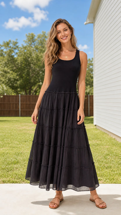 Front full view of woman wearing Black sleeveless scoop neck tiered maxi dress