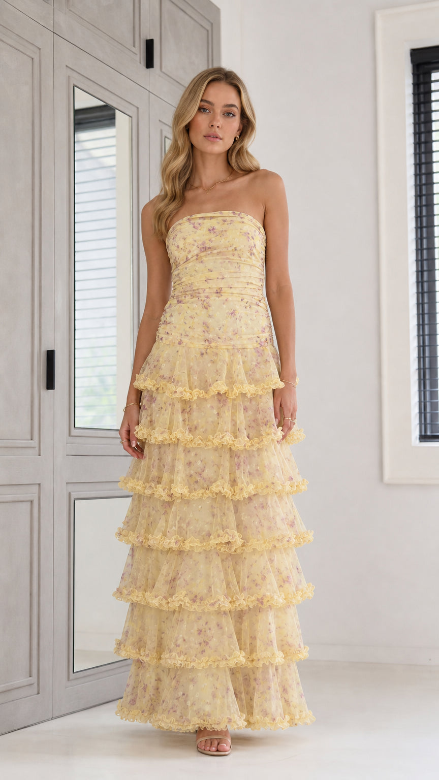 Front view of yellow strapless tiered floral maxi dress