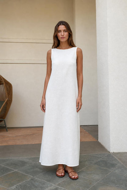 Front view of woman wearing white sleeveless maxi dress with sandals