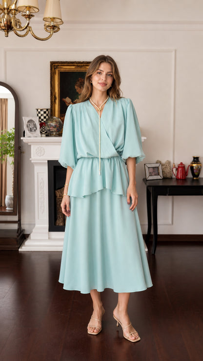 Model wearing mint green V-neck layered midi dress, front view