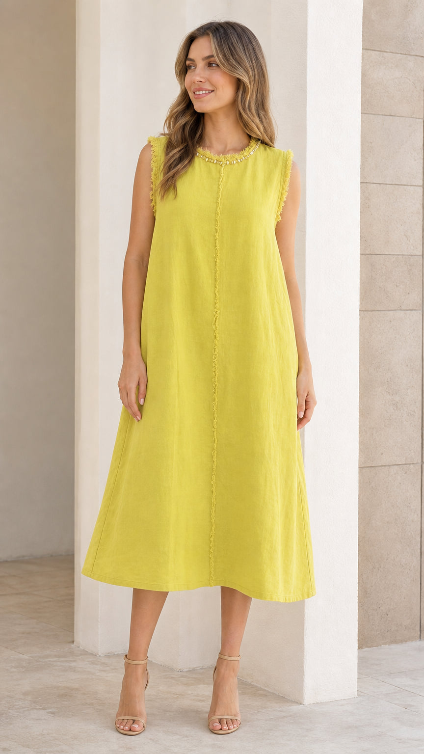 Front view of woman wearing chartreuse sleeveless midi dress with frayed trim