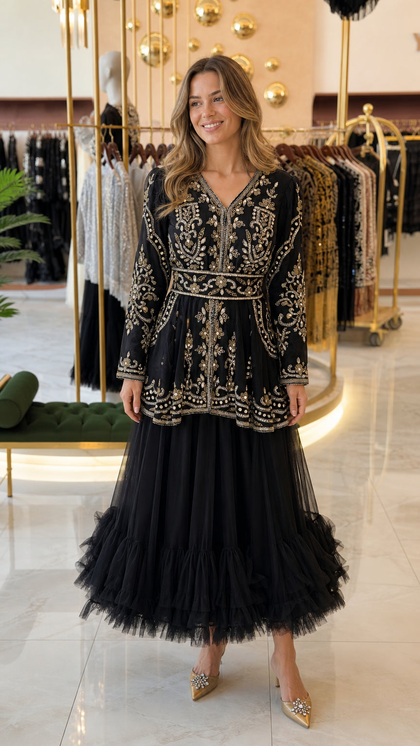 Front view of black embroidered peplum dress with tiered tulle skirt