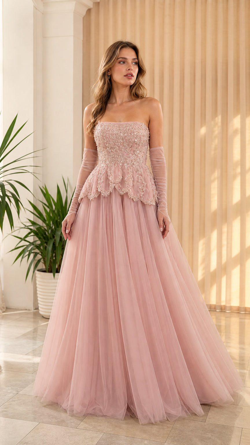 Front view of woman wearing strapless dusty pink beaded peplum tulle evening gown with opera gloves
