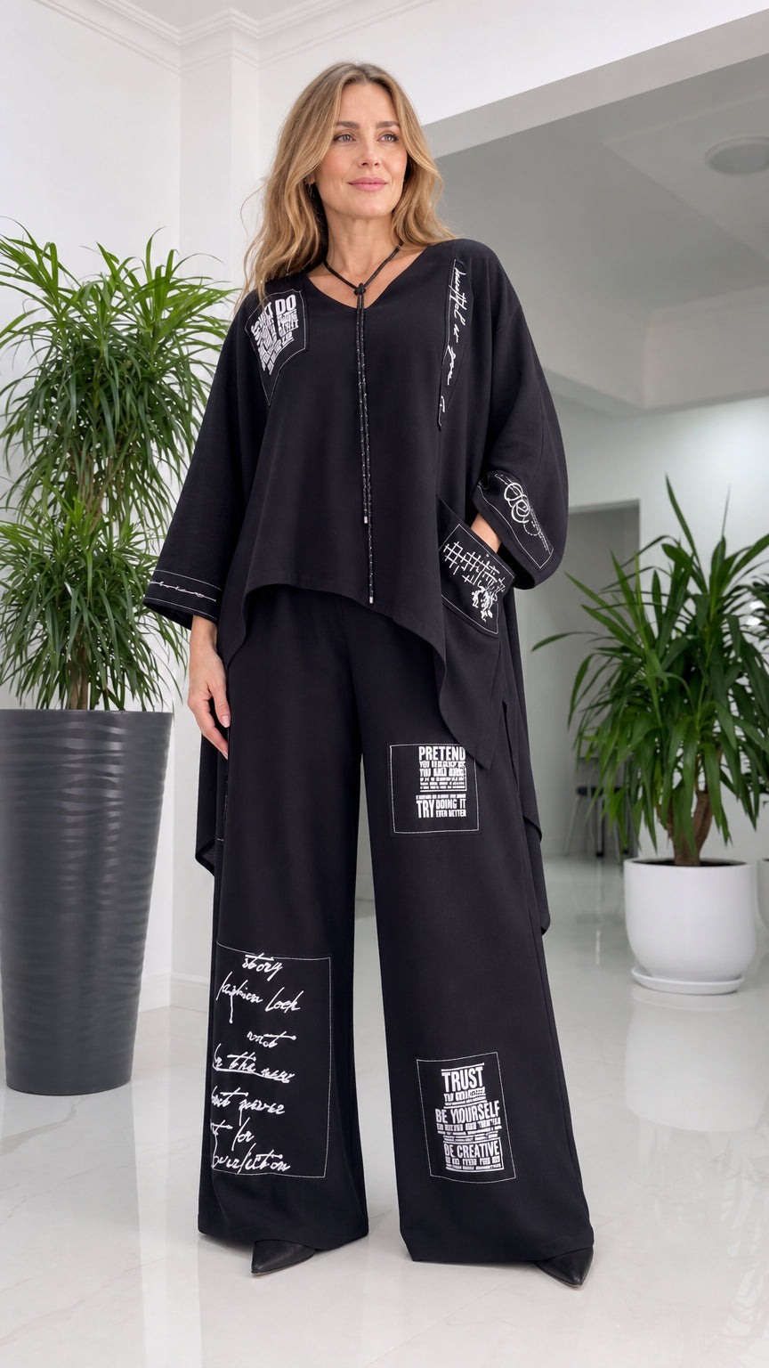 Front view of woman wearing black typography print two-piece pant set