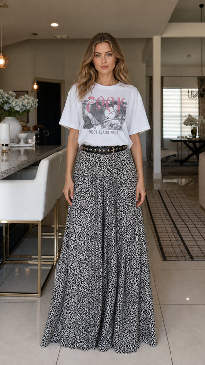 Model wearing white graphic tee and leopard print wide-leg pants from front