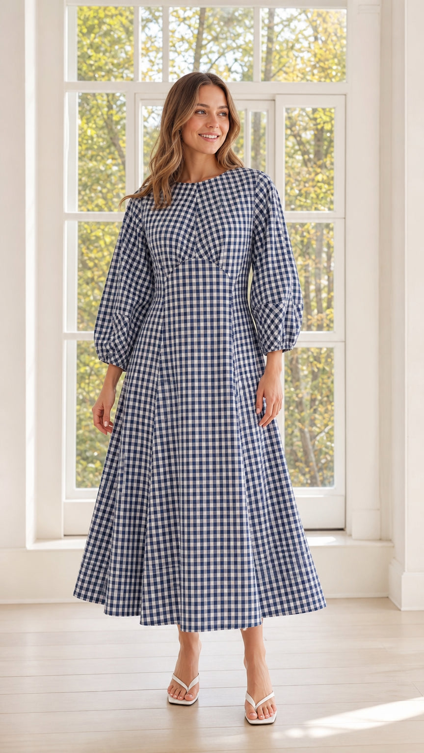 Front view of woman wearing blue gingham midi dress