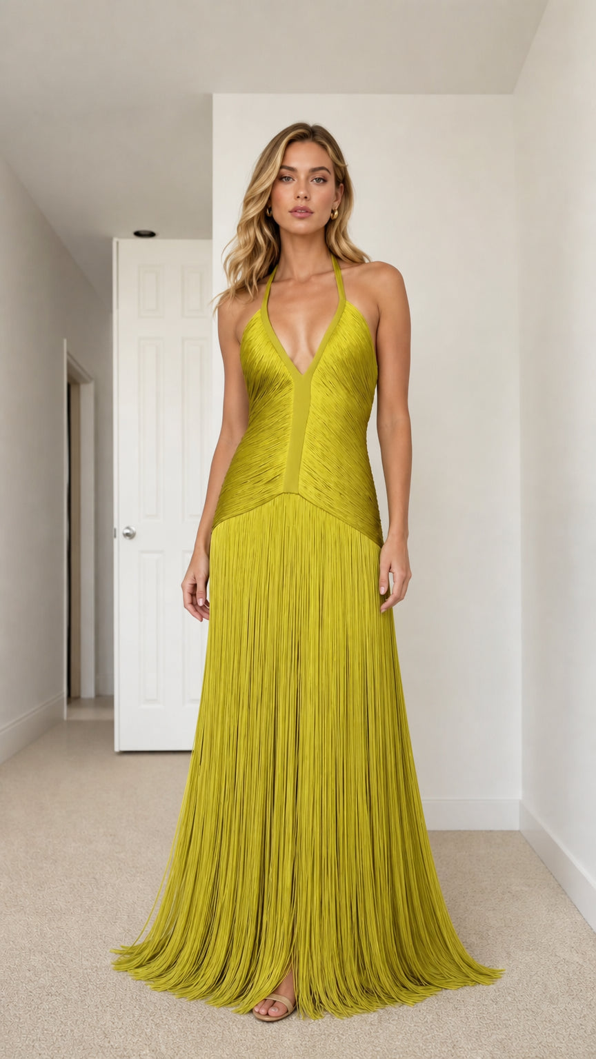 Front view of model wearing chartreuse deep plunge halter fringe maxi dress