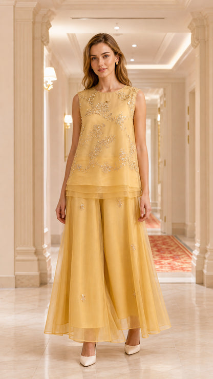 Front view of model wearing gold embroidered sleeveless tiered tunic and palazzo pant set