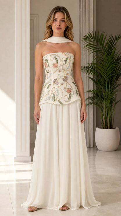 Front view of model wearing ivory strapless beaded floral corset evening gown with scarf