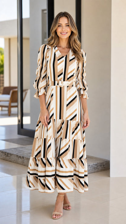 Front view of woman wearing beige geometric striped tiered midi dress