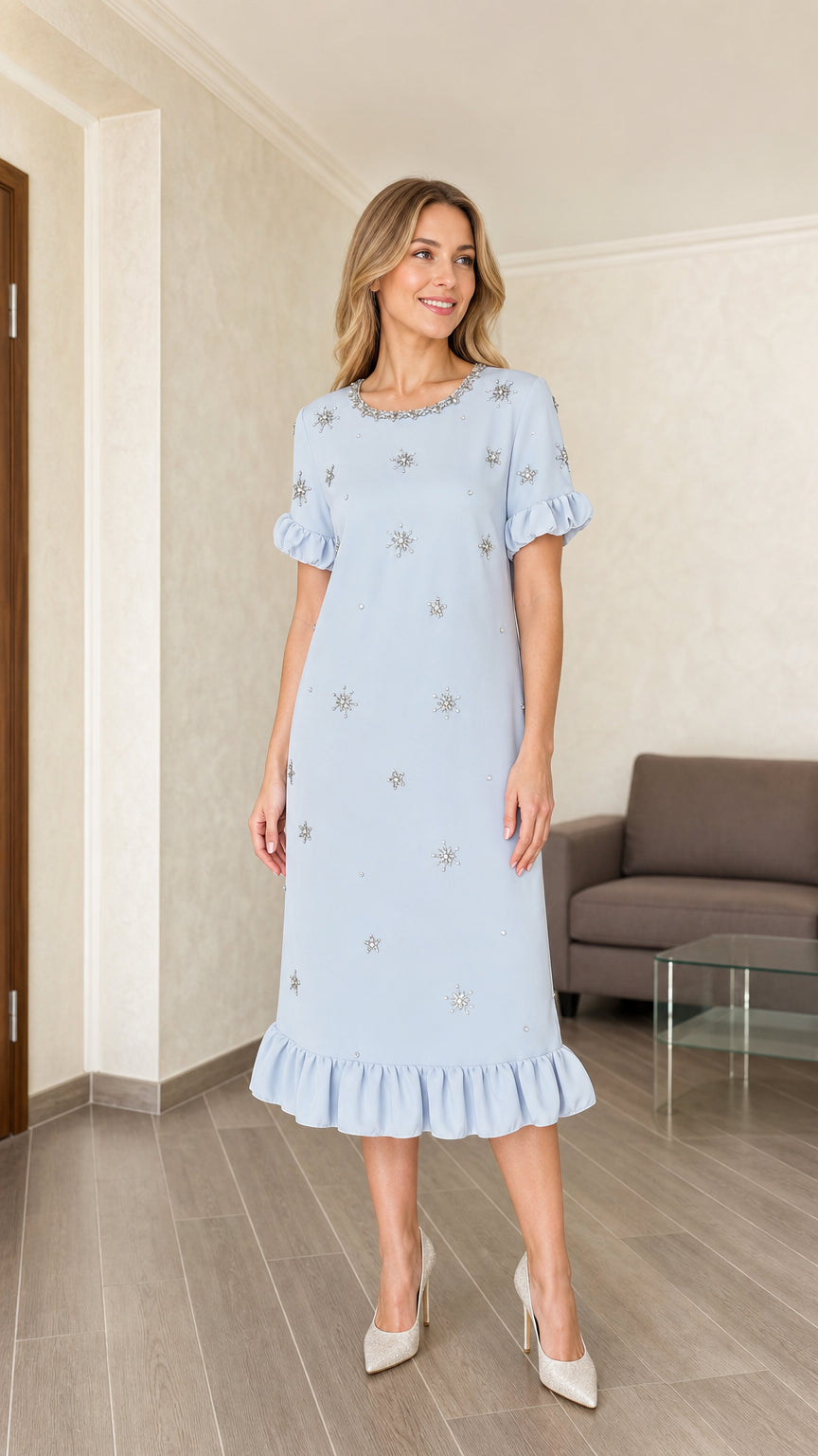 Model wearing light blue embellished midi dress with ruffle hem, front view
