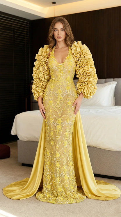 Front view of yellow embroidered evening gown with ruffle sleeves and train