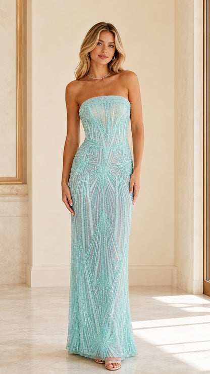 Front full-length view of model wearing sky blue strapless beaded sequin maxi gown