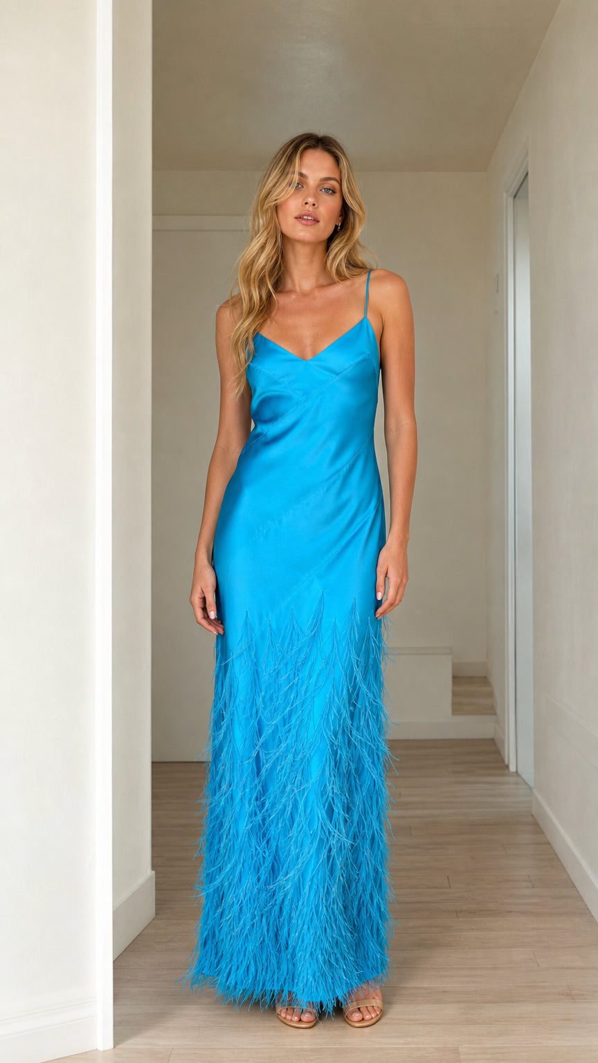 Front view of woman wearing bright blue satin feather trim maxi dress