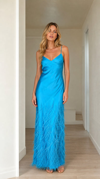 Front view of woman wearing bright blue satin feather trim maxi dress