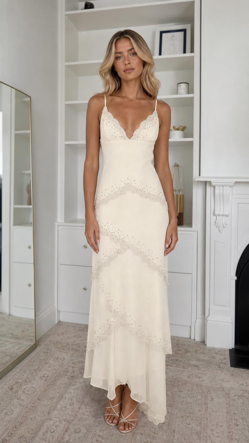 Front view of model wearing champagne embellished tiered maxi dress